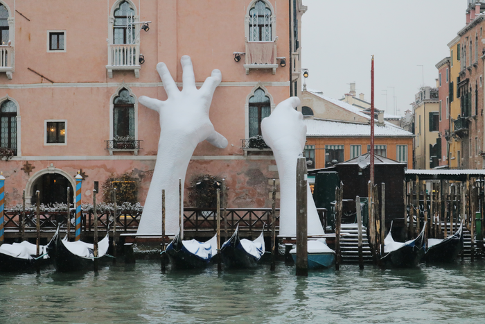 Giant Hands, called Support, in a rare snowy event in a floating city of Venice