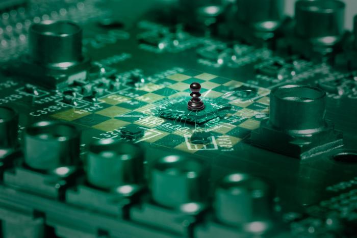 Photograph of the quantum chip hosting the 16 quantum dot crossbar array, seamlessly integrated to a chessboard motif.