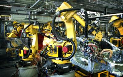 Robots at Work on Assembly Line in a Car Factory
