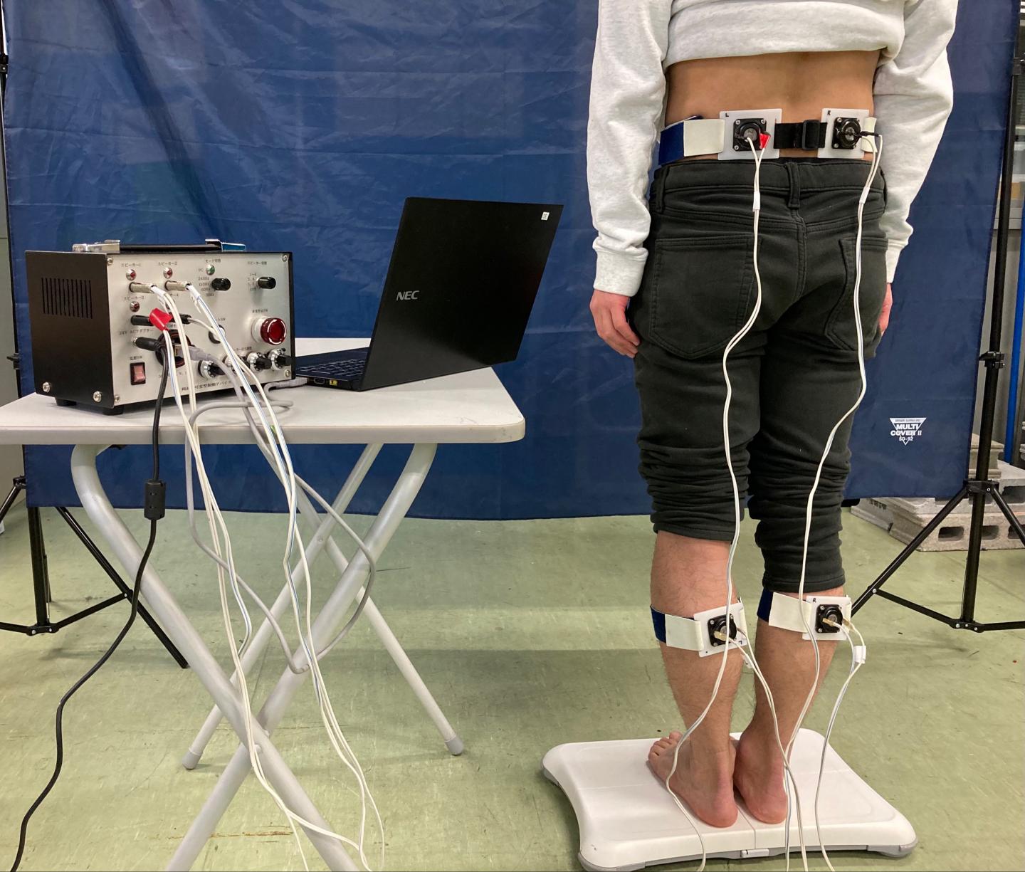 Components of the variable frequency local vibratory stimulation device and the experimental set up for the participant.