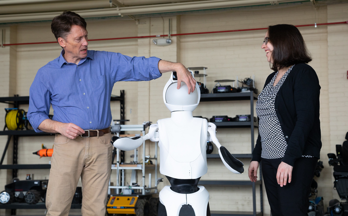 Researchers with robot