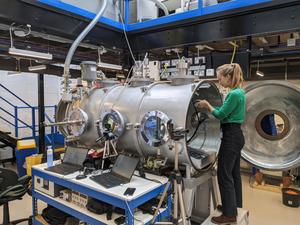 Lonneke Roelofs next to the Mars chamber at the Open University, Milton Keynes (UK)