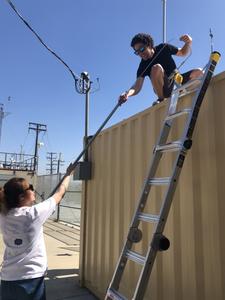 Grad students installing monitoring equipment