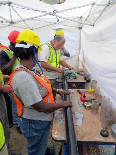 Bernie Owen and Veronica Muiruri Opening a Core in the Magadi Field Tent