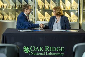 Hood Whitson, chief executive officer of Element3, and Cynthia Jenks, associate laboratory director for the Physical Sciences Directorate, shake hands