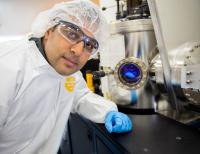 Technologist Vivek Dwivedi in Front of a Sputtering Reactor