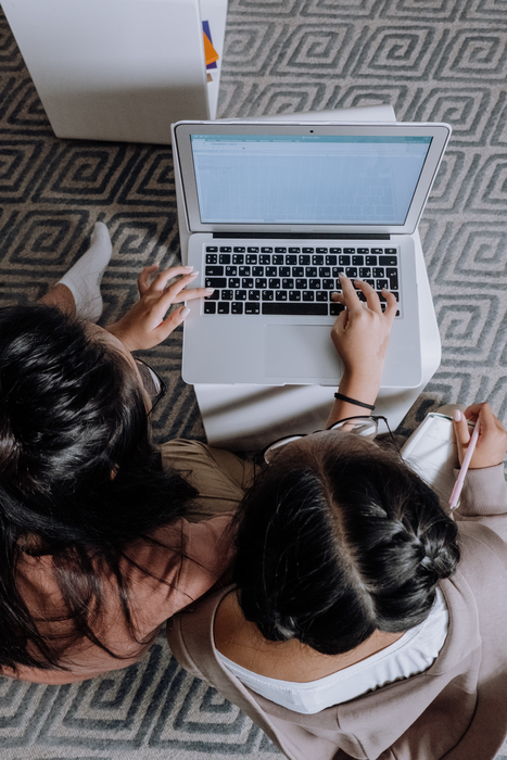 Two girls using a laptop