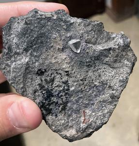 Rare find: A Diamond sticking out of a piece of kimberlite rock