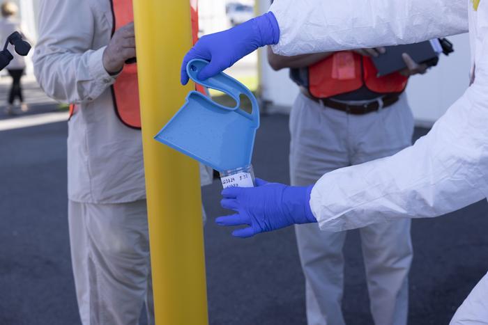 Simulated nuclear forensics debris is collected into a collection cup at Idaho National Laboratory.