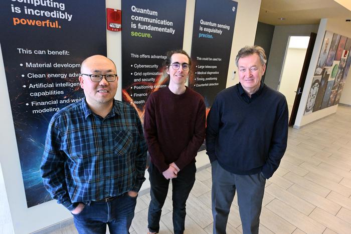 Scientists in front of quantum display panels