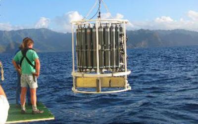 Photo of a Researcher on a Research Vessel Watching Seawater Sampling Equipment