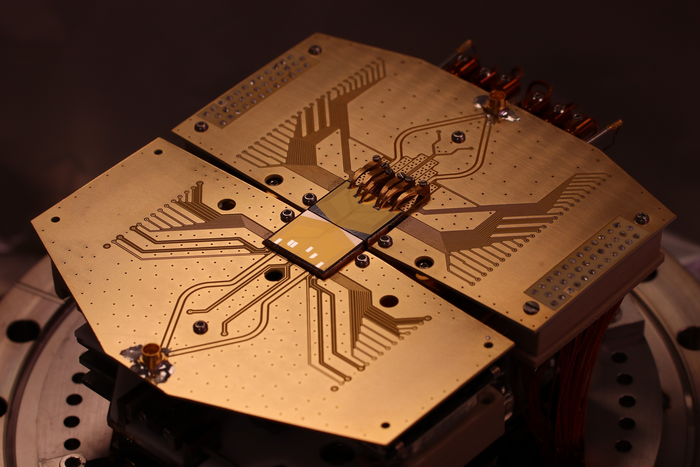 Quantum computer setup at the University of Sussex with two quantum computer microchips where quantum bits are transferred from one microchip to another with record speed.