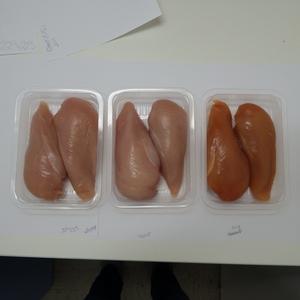 transparent containers containing chicken of different colours