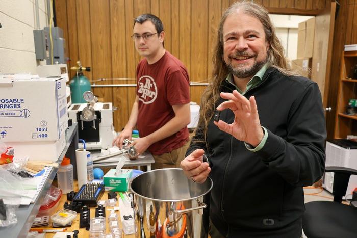 Ph.D. candidate Keegan Walkup (at left) and physicist Patrick Huber work in the new lab that Huber is establishing to look for evidence of dark matter inside the crystal lattice structures of old rocks.