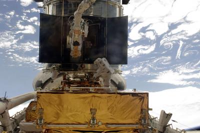 Astronauts at Work on Hubble