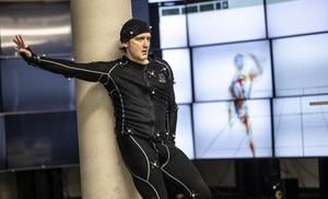 The artist Tomáš Danielis during a dance performance in a motion-capturing suit.