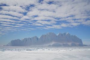 Iceberg collapsed from an Antarctic ice sheet with clouds influenced by gravtity waves