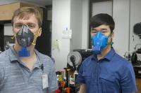 Two members of Medical University of South Carolina model mask prototypes