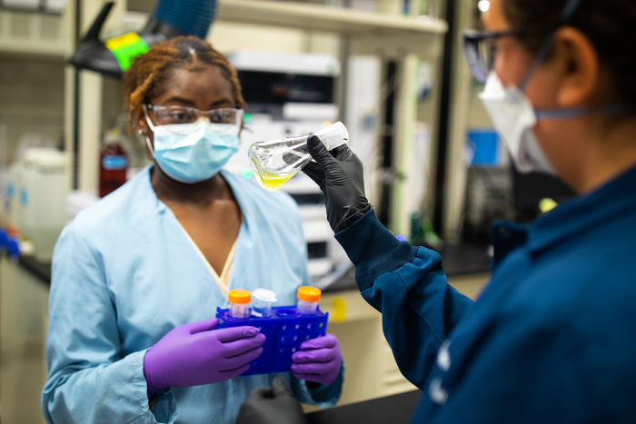 Sandia intern prepares research sample.