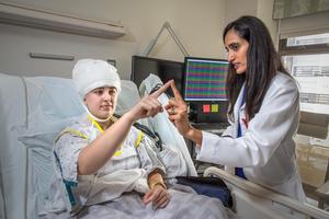 Cedars-Sinai neurologist Chrystal Reed, MD, PhD, with a patient in the epilepsy monitoring unit.