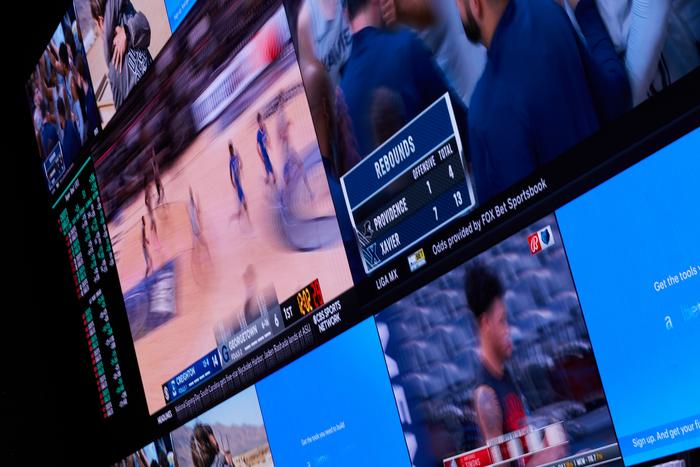 Casino sportsbook TV screens showing basketball games
