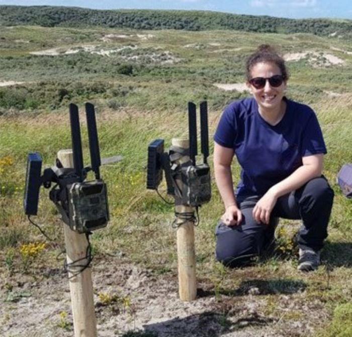 Researcher with wild life cameras