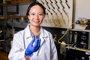 Rice University Ph.D. student Zhen Liu with container that keeps VOCs from coating stored surfaces