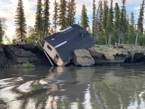 Infrastructure in permafrost areas is threatened by river bank erosion, Mackenzie River Delta, Canada.