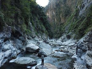 standing on a boulder in a river channel