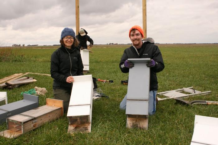 Joy O'Keefe (left) and Reed Crawford (right) with bat boxes