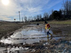 Megan Rippy collects soil samples at a stormwater detention basin along Interstate 95 in Northern Virginia.