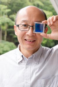 NTU Professor Sun Xiaowei Holding his Smart Window Invention