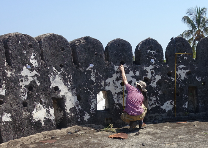Dr Alessandro Ghidoni records a ship graffito in the southwestern tower of Zanzibar Fort. (Credit: John P Cooper)