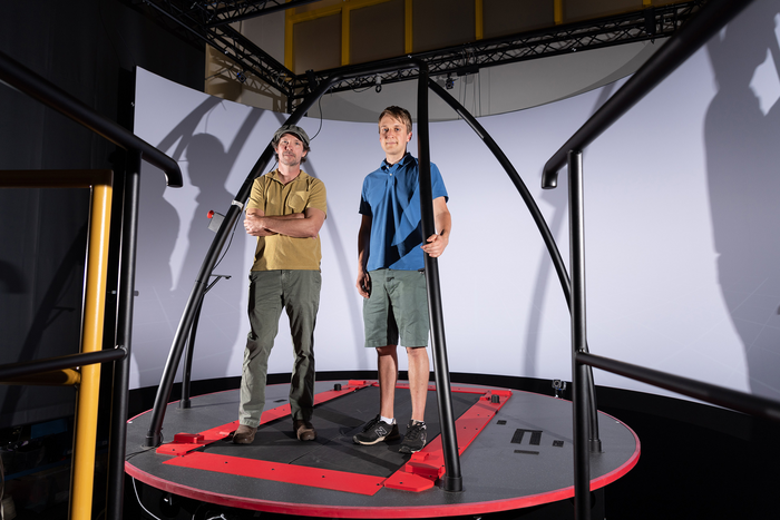 Pawel Golyski and Associate Professor of Mechanical Engineering Gregory Sawicki (left) with the CAREN (Computer Assisted Rehabilitation Environment) system at Georgia Tech's EPIC Lab.