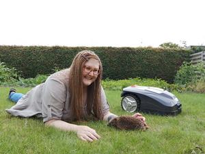 Sophie with hedgehog and robotic lawn mower