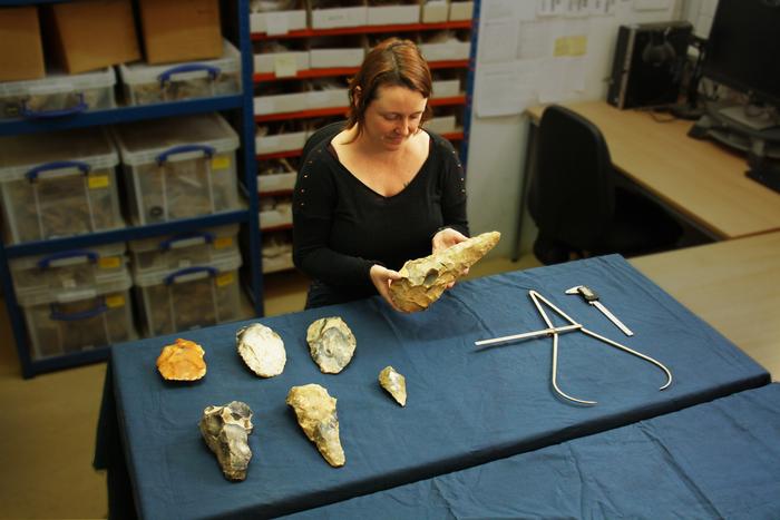 ASE Senior Archaeologist Letty Ingrey inspects the largest handaxe