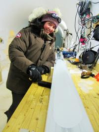 Emilie Capron with an ice core in the sub surface ice-core laboratory