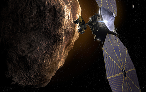 Illustration of the Lucy spacecraft near a large asteroid