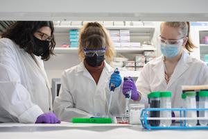 URI Professor Jaime Ross, at left, in her lab