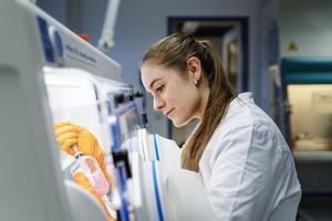 Researcher experimenting in an anaerobic box