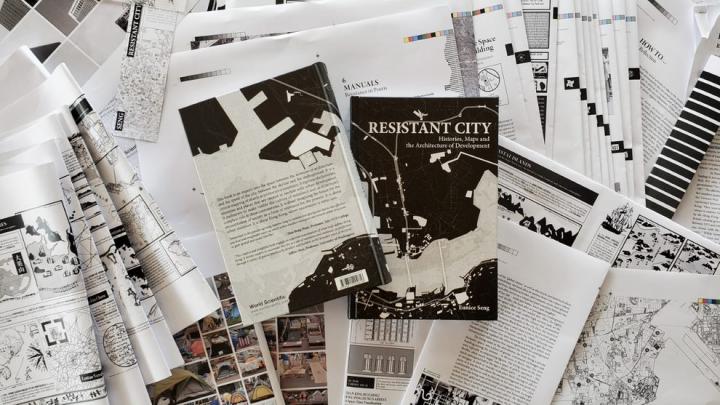 Copies of Resistant City amidst test-prints of the book.