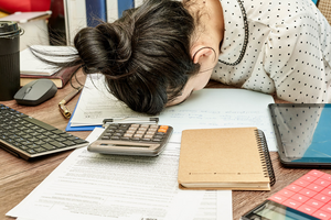 An overworked woman at her desk