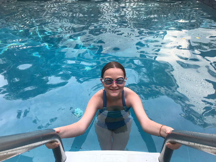 Child on pool ladder