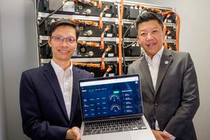 NTU Asst Prof  Hung Dinh Nguyen (left) and Durapower CEO Mr Kelvin Lim (right) in the container-sized energy storage solution testbed