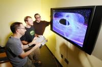 Researchers with Black Hole Illustration