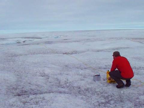 Adam Booth Monitoring a Seismic Explosion on the Greenland Ice Sheet