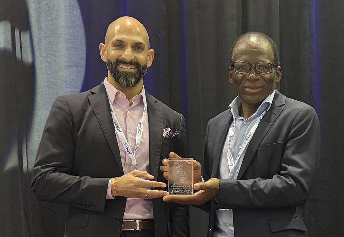 Prof Masimirembwa receives his award at the Precision Medicine World Conference 2025