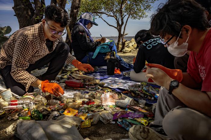 Volunteers record data on branded plastic waste during a brand audit in Jakarta, Indonesia.