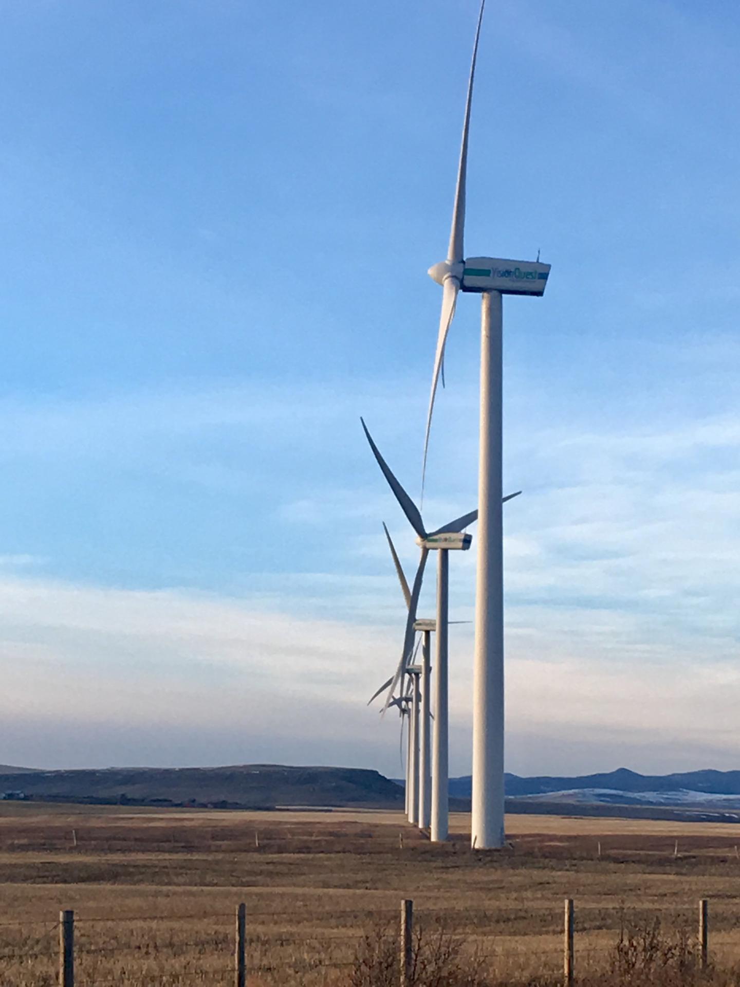 Wind turbines in wake-steering arrangement, with upwind turbines turned relative to the downwind turbine (foreground).