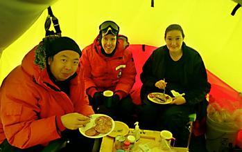 Three Researchers Share a Meal in an Antartica Tent